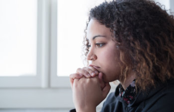 side of a worried young woman