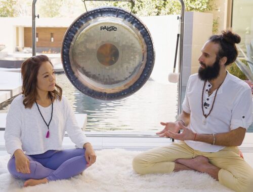 A woman and a man sitting on the floor.